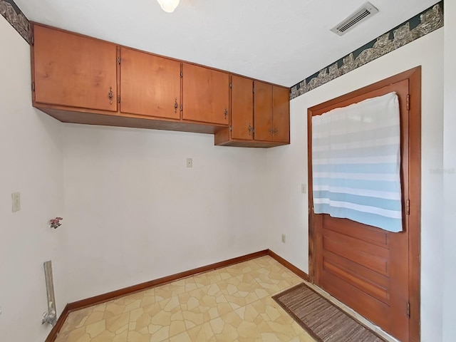 laundry room featuring laundry area, light floors, visible vents, and baseboards