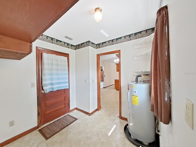 entryway with visible vents, electric water heater, and baseboards