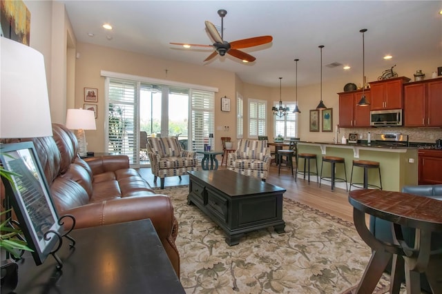 328 Siena Vista Pl, Sun City Center, FL 33573 - living room featuring ceiling fan, light wood finished floors, visible vents, and recessed lighting