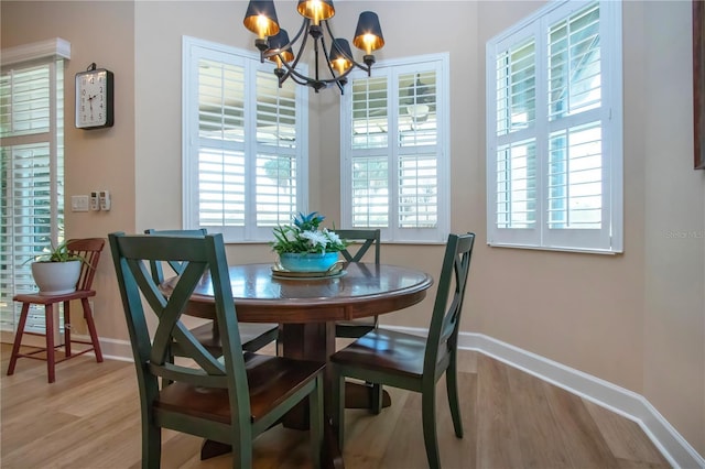 328 Siena Vista Pl, Sun City Center, FL 33573 - dining area with a chandelier, light wood finished floors, and baseboards