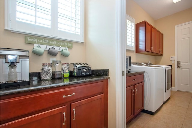 328 Siena Vista Pl, Sun City Center, FL 33573 - laundry room with a healthy amount of sunlight, cabinet space, washer and clothes dryer, and light tile patterned floors