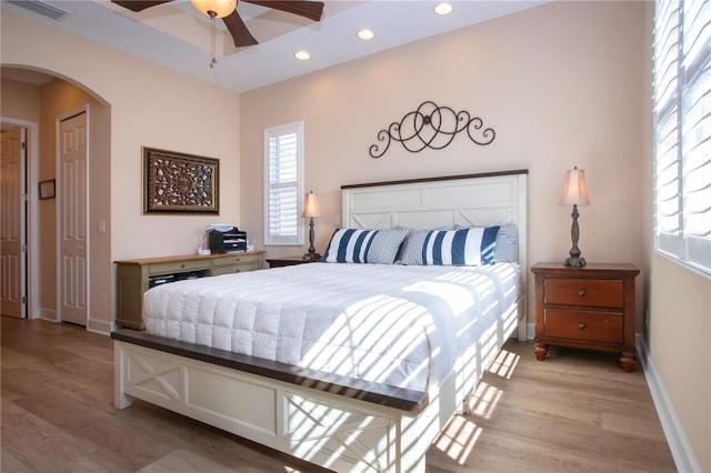 328 Siena Vista Pl, Sun City Center, FL 33573 - bedroom with light wood-style floors, visible vents, arched walkways, and recessed lighting
