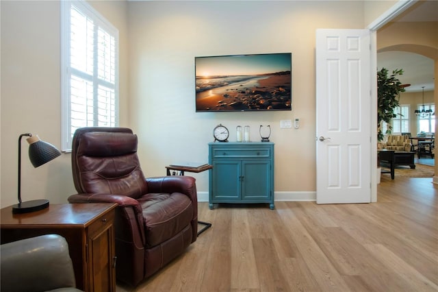 328 Siena Vista Pl, Sun City Center, FL 33573 - sitting room featuring arched walkways, baseboards, and light wood finished floors
