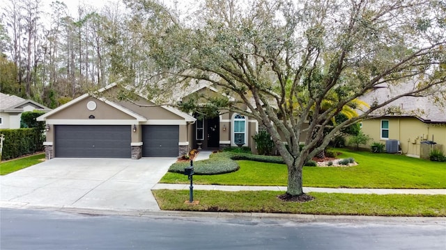 view of front of property featuring a garage, central AC unit, a front lawn, and stucco siding