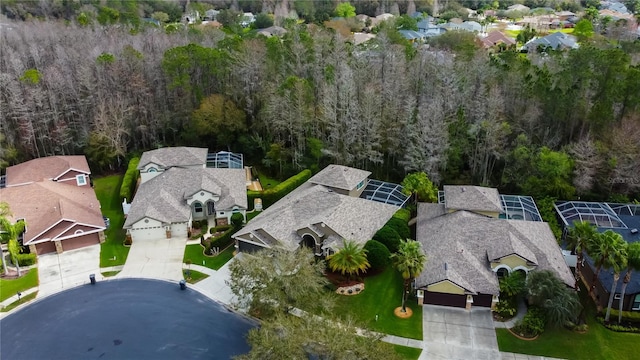 aerial view featuring a forest view and a residential view