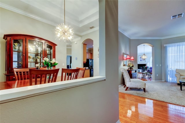 interior space featuring arched walkways, a chandelier, and visible vents