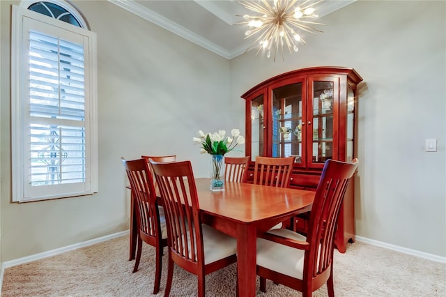 carpeted dining area featuring an inviting chandelier, baseboards, and ornamental molding