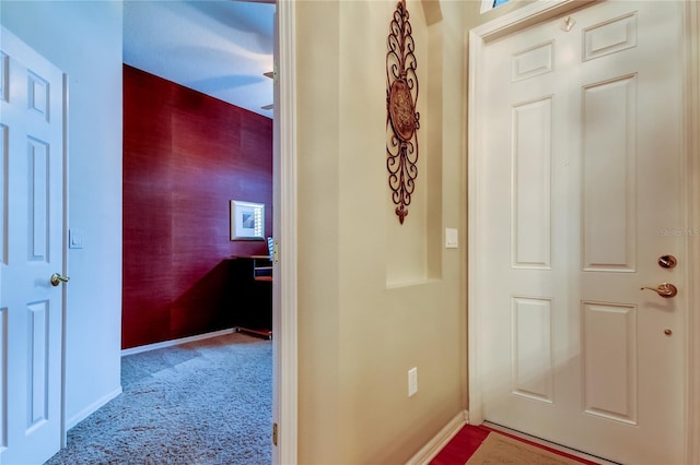 hall with carpet and baseboards