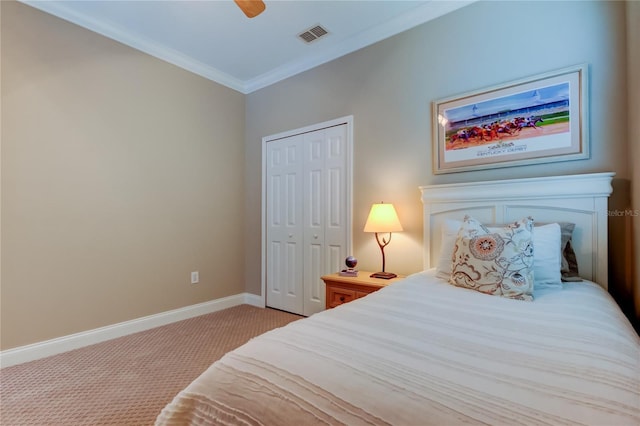 bedroom featuring a closet, visible vents, ornamental molding, carpet flooring, and baseboards