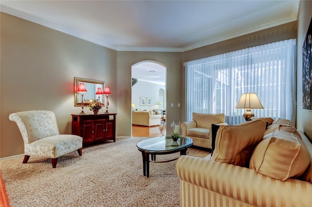 living area featuring carpet, crown molding, arched walkways, and baseboards