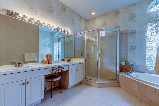 full bathroom featuring a shower stall, double vanity, a sink, and wallpapered walls