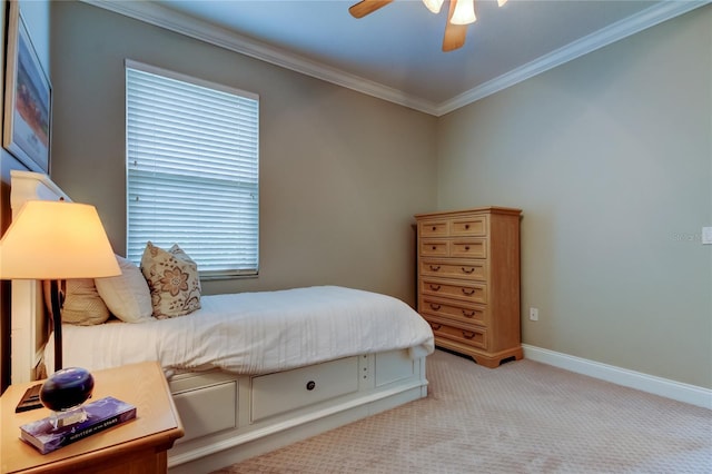 bedroom with light carpet, ceiling fan, baseboards, and crown molding