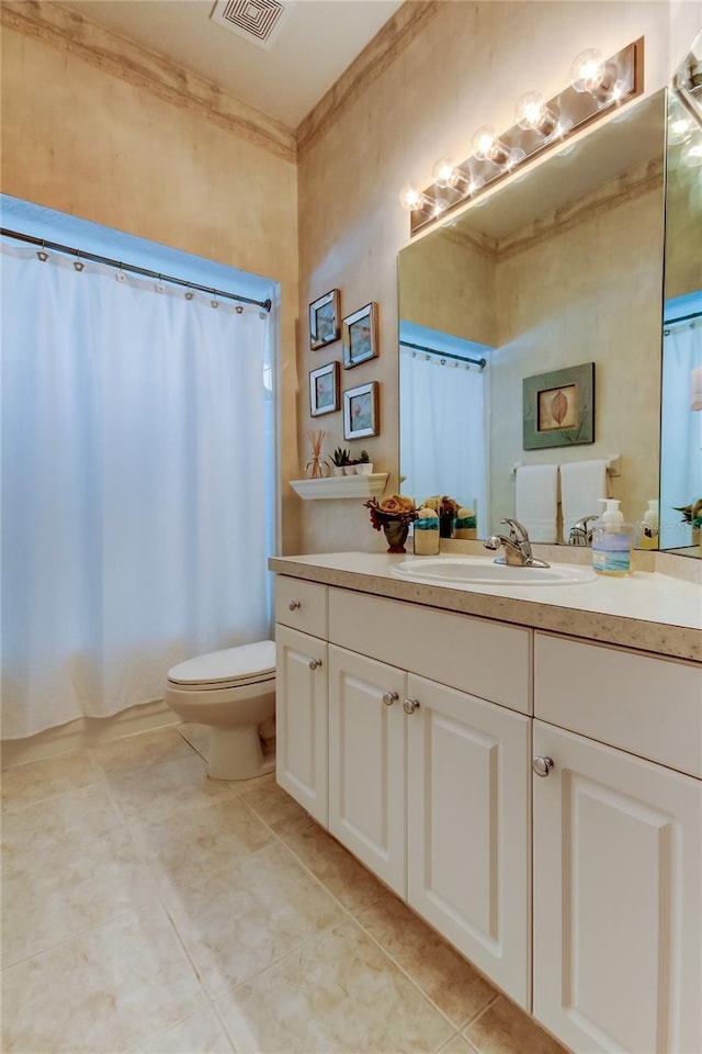 bathroom featuring visible vents, toilet, ornamental molding, vanity, and tile patterned flooring