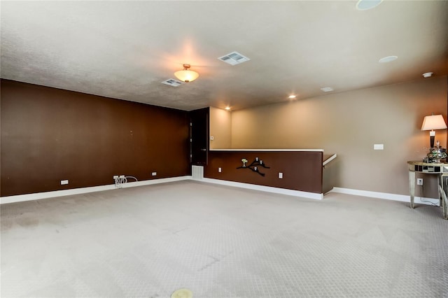 interior space featuring carpet floors, baseboards, and visible vents