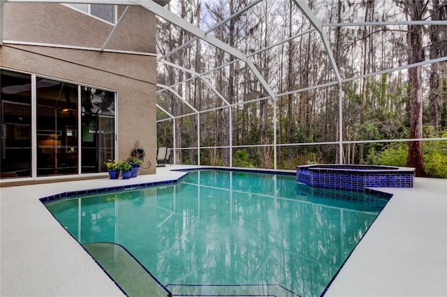 view of pool featuring a lanai, a patio area, and a pool with connected hot tub