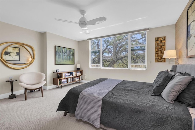 carpeted bedroom with a ceiling fan and baseboards