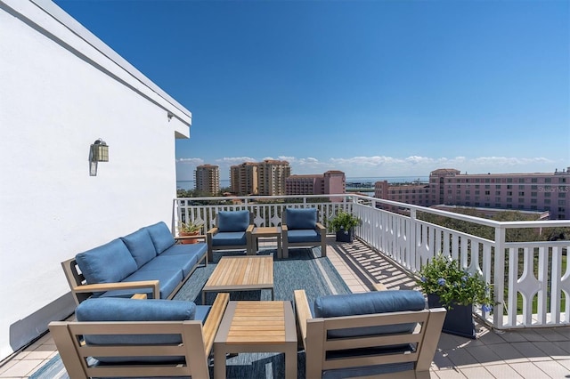 exterior space with a view of city, a balcony, and an outdoor hangout area