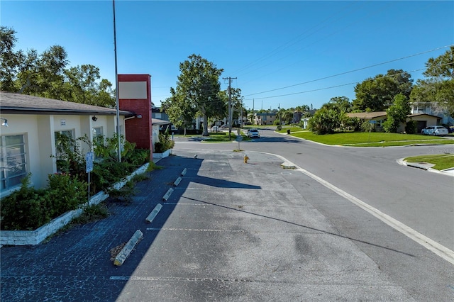 view of road featuring a residential view and curbs