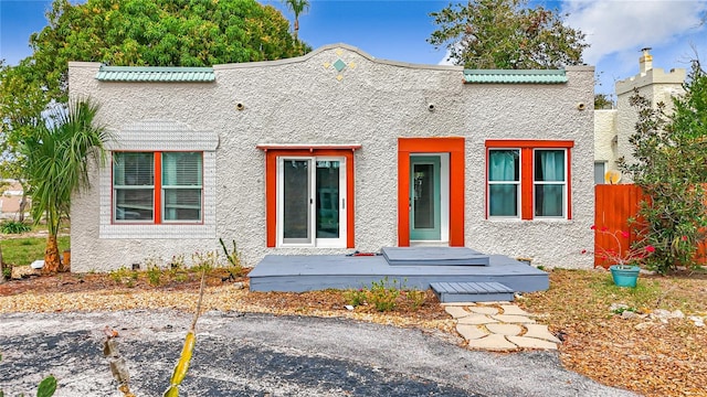 view of front of property featuring crawl space, fence, and stucco siding