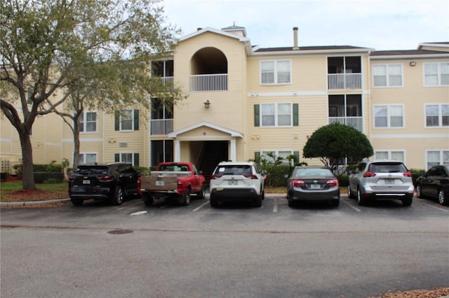 view of building exterior featuring uncovered parking