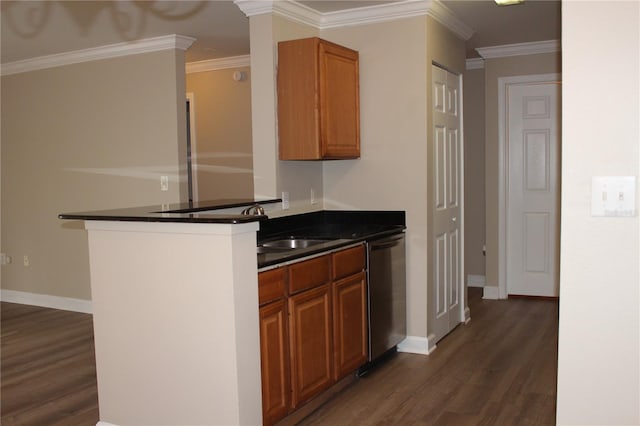 kitchen with brown cabinets, dark countertops, dark wood-type flooring, a sink, and dishwasher