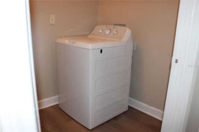 washroom with laundry area, washer / clothes dryer, dark wood-style flooring, and baseboards