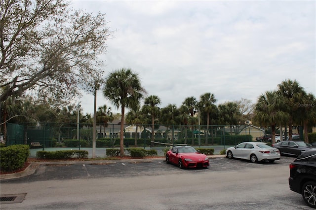 uncovered parking lot featuring fence