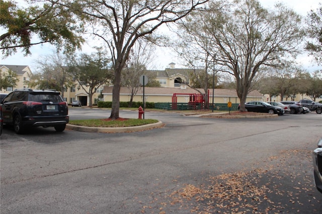 view of street with traffic signs, a residential view, and curbs