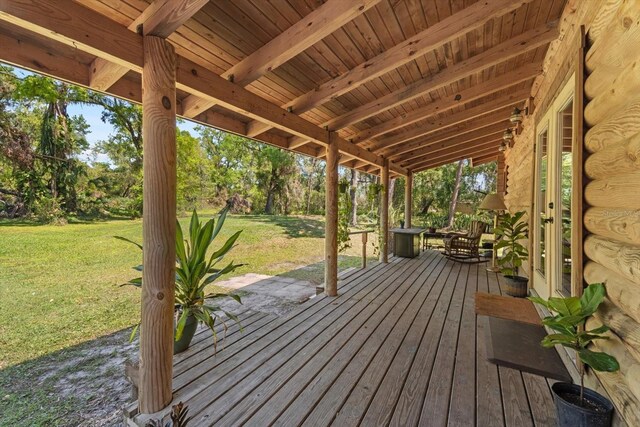 wooden deck featuring a yard