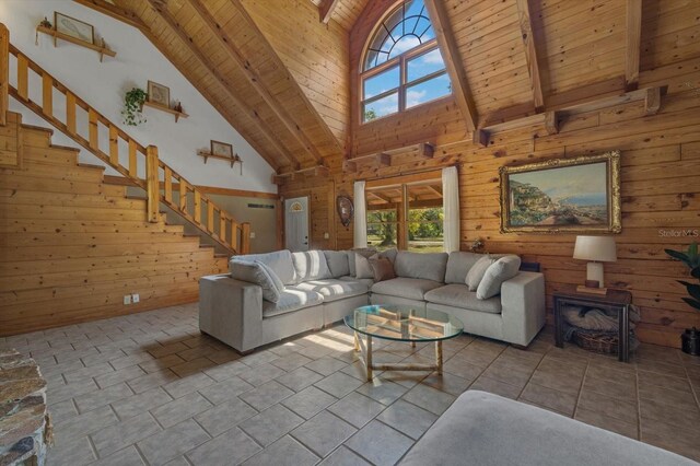 tiled living room with stairs, wood walls, and wooden ceiling