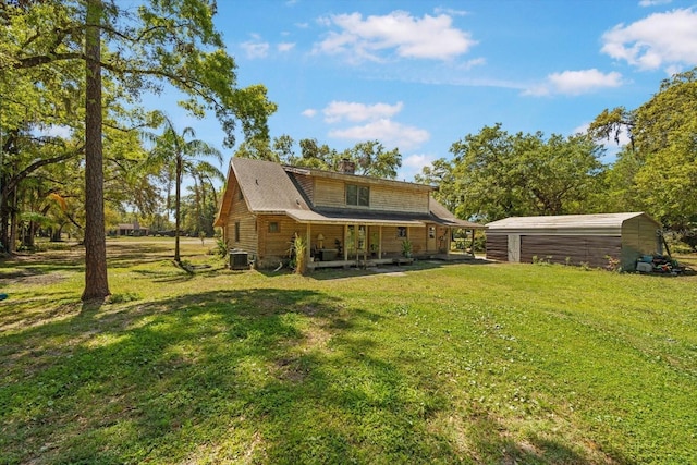 back of house with a yard and central air condition unit