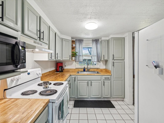 kitchen with wooden counters, a sink, white range with electric stovetop, and gray cabinetry