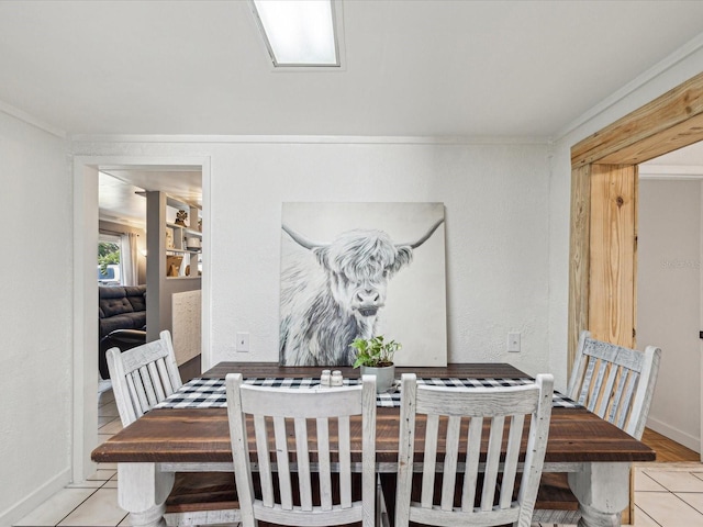 dining space featuring baseboards and ornamental molding