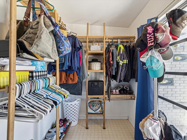 walk in closet with tile patterned floors