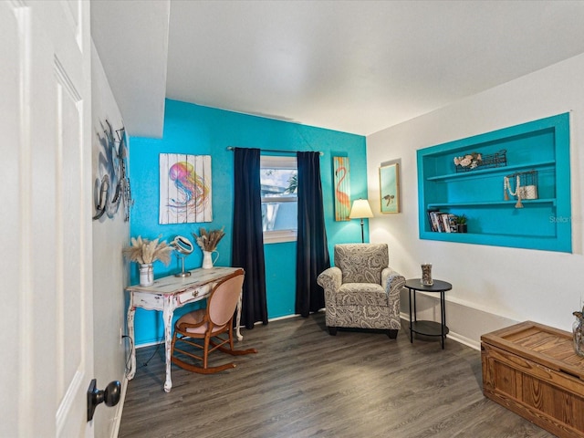 sitting room with baseboards and wood finished floors