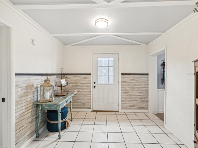 doorway to outside featuring a wainscoted wall, light tile patterned floors, and ornamental molding