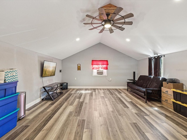 sitting room featuring light wood finished floors, a ceiling fan, vaulted ceiling, cooling unit, and baseboards