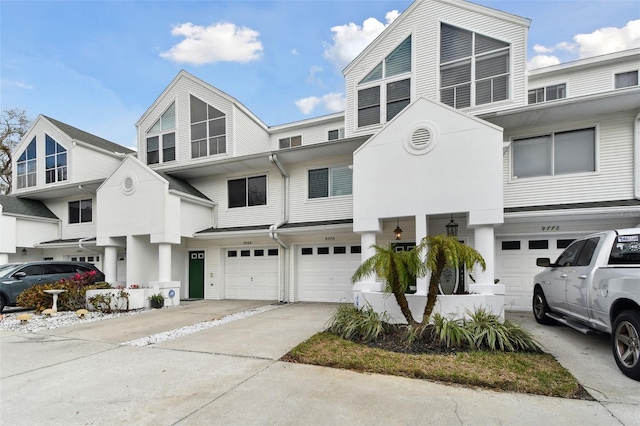 multi unit property featuring driveway and a garage