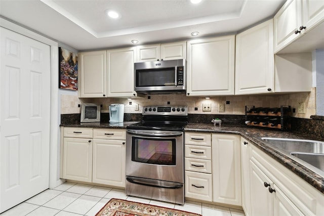 kitchen with stainless steel appliances and white cabinetry