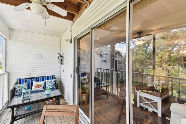 sunroom / solarium featuring plenty of natural light and a ceiling fan