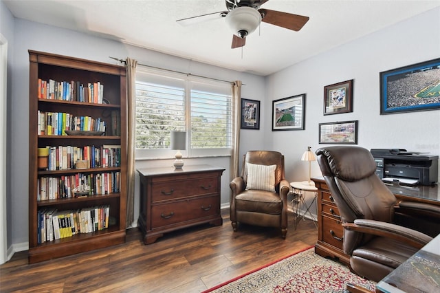 office area featuring a ceiling fan, dark wood finished floors, and baseboards