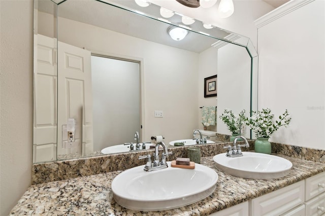 bathroom featuring double vanity and a sink