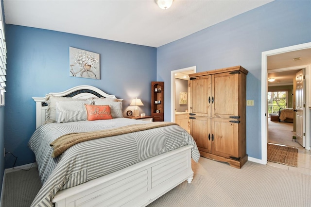 bedroom with baseboards and light colored carpet