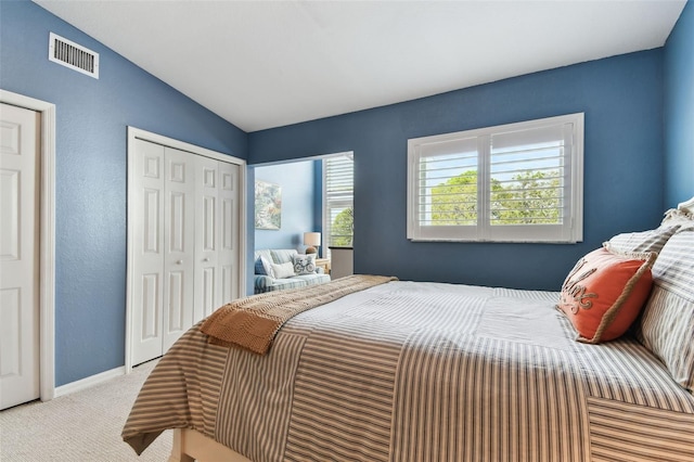 bedroom with light carpet, baseboards, visible vents, and vaulted ceiling