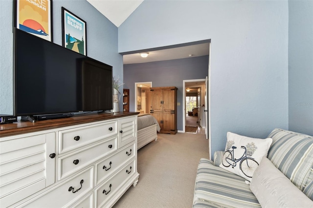 bedroom with lofted ceiling and light colored carpet