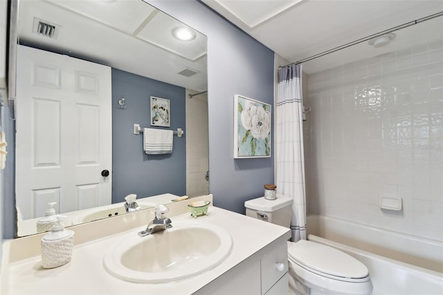 bathroom featuring visible vents, vanity, toilet, and shower / bathtub combination with curtain