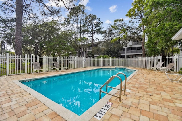 pool with fence and a patio