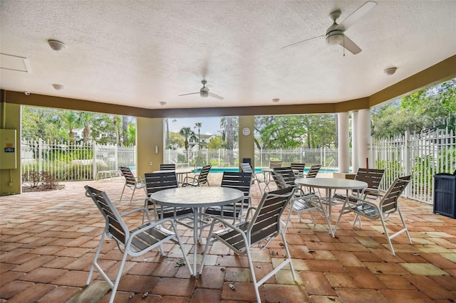 view of patio / terrace featuring a ceiling fan, outdoor dining area, and fence