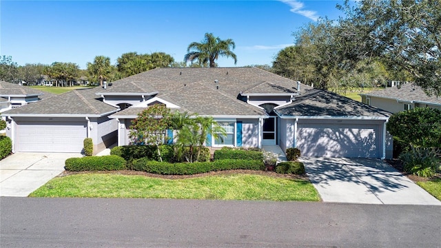 view of front of home with stucco siding, an attached garage, driveway, and roof with shingles