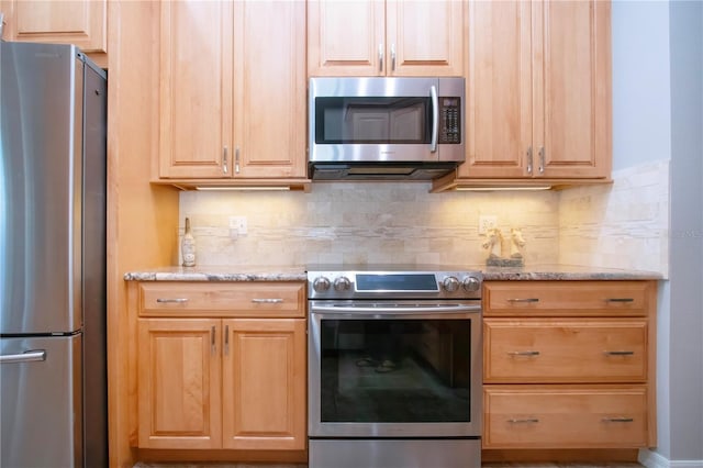 kitchen featuring light stone counters, light brown cabinets, tasteful backsplash, and appliances with stainless steel finishes